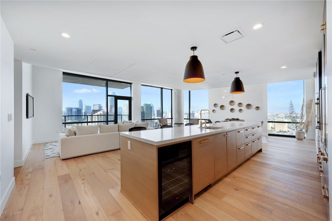 Modern high-rise condo kitchen with downtown Austin skyline views