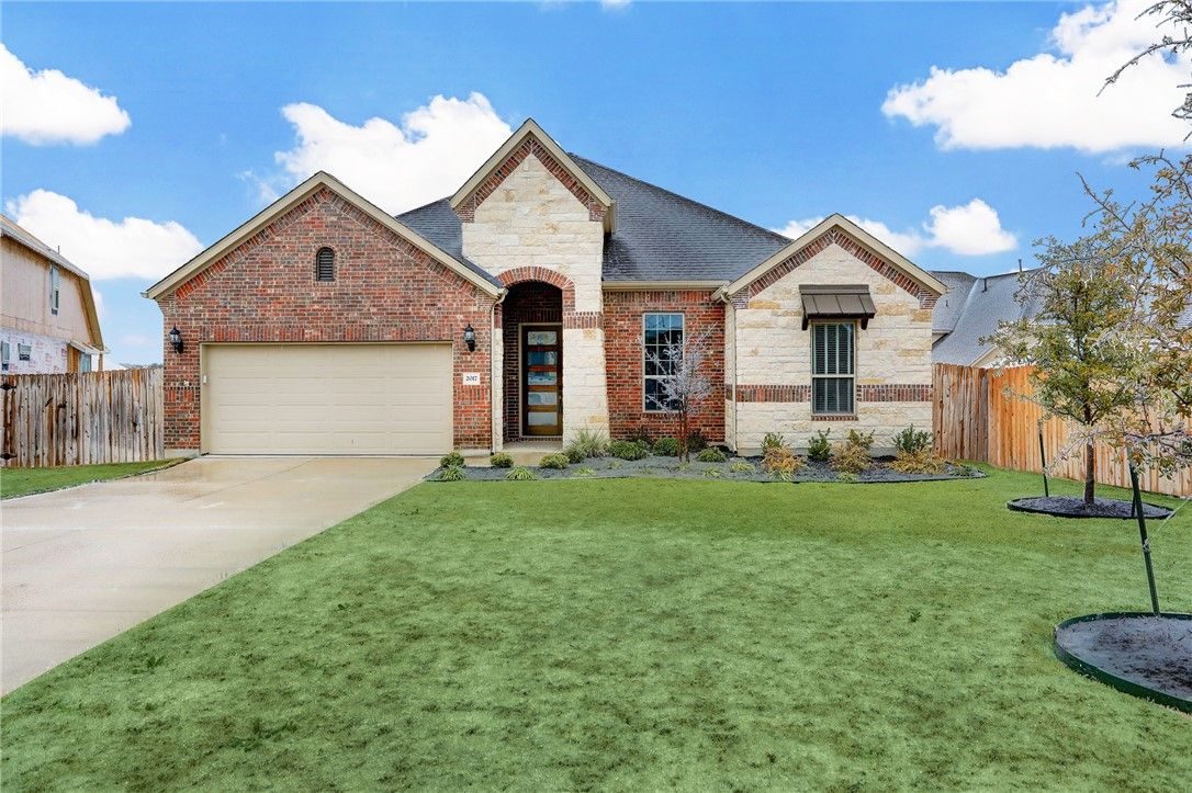 Stone and brick Hill Country home exterior